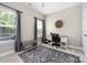 Bright bedroom featuring an office space, a large rug, and two large windows offering natural light at 12220 Huntersville Concord Rd, Huntersville, NC 28078