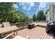 Inviting outdoor deck furnished with comfortable seating, a fire pit, and a grill, perfect for entertaining at 12220 Huntersville Concord Rd, Huntersville, NC 28078