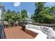 Relaxing deck with stylish outdoor seating and a serene view of lush trees and landscaping at 12220 Huntersville Concord Rd, Huntersville, NC 28078