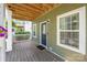 Inviting front porch with a wooden deck, a green exterior, and a 'Welcome Home' doormat at 12220 Huntersville Concord Rd, Huntersville, NC 28078