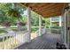 Charming front porch with hanging ferns, purple flowers, and a welcoming entryway at 12220 Huntersville Concord Rd, Huntersville, NC 28078