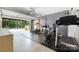 Open garage with a home gym featuring a power rack, treadmill, and spin bike at 12220 Huntersville Concord Rd, Huntersville, NC 28078