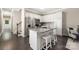 Modern kitchen features granite counters, stainless steel appliances, a central island and access to the staircase at 12220 Huntersville Concord Rd, Huntersville, NC 28078