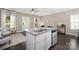 Bright kitchen with granite countertops, stainless steel appliances, island seating, and an open layout at 12220 Huntersville Concord Rd, Huntersville, NC 28078
