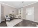 Cozy living area with natural light, comfortable seating, dark wood floors, and neutral wall color at 12220 Huntersville Concord Rd, Huntersville, NC 28078