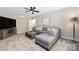 Comfortable living room with a gray sectional, ceiling fan, and large television at 12220 Huntersville Concord Rd, Huntersville, NC 28078