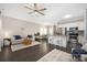 Open-concept living area with kitchen, dining space, and a comfortable seating area with dark hardwood floors at 12220 Huntersville Concord Rd, Huntersville, NC 28078