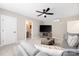 Comfortable living room with a gray sectional, ceiling fan, and large television at 12220 Huntersville Concord Rd, Huntersville, NC 28078