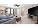 Cozy living room with comfortable sectional sofa, large television, and a ceiling fan at 12220 Huntersville Concord Rd, Huntersville, NC 28078