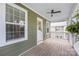 Covered porch featuring wooden floors, exterior view of house, and ceiling fan at 12220 Huntersville Concord Rd, Huntersville, NC 28078