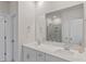 Bathroom showcasing double sinks, quartz countertops, framed mirror, and shower with glass door at 1344 Sweet Pea St, Monroe, NC 28110