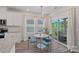 Breakfast nook featuring a round table with blue chairs, bright natural light, and access to outdoor seating at 1344 Sweet Pea St, Monroe, NC 28110