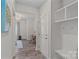 Entryway with Luxury Vinyl flooring and views into sitting room. Features a mud room with shelving at 1344 Sweet Pea St, Monroe, NC 28110
