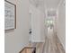 Inviting hallway with wood-look floors, crown molding and views into the living area at 1344 Sweet Pea St, Monroe, NC 28110