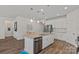Spacious kitchen island with stainless steel appliances, white cabinetry, and seating for four at 1344 Sweet Pea St, Monroe, NC 28110