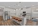 Kitchen featuring a large island with barstool seating, stainless steel appliances, and white cabinetry at 1344 Sweet Pea St, Monroe, NC 28110