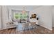 Cozy living room with large windows, neutral-toned furniture, stylish lamps, and woven ceiling light at 1344 Sweet Pea St, Monroe, NC 28110