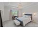 This main bedroom features a tray ceiling, accent lighting, and seating at the window at 1344 Sweet Pea St, Monroe, NC 28110