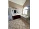 Vaulted ceiling bathroom featuring a soaking tub and dual sink vanity at 140 Hunters Hill Dr, Statesville, NC 28677