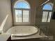 Relaxing bath with a large window view and stylish fixtures at 140 Hunters Hill Dr, Statesville, NC 28677