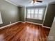 Inviting bedroom featuring hardwood floors, a large window, and ample natural light at 140 Hunters Hill Dr, Statesville, NC 28677