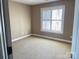 Cozy bedroom featuring plush carpet, neutral paint, and a bright window at 140 Hunters Hill Dr, Statesville, NC 28677