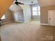 Large bonus room with carpet, ceiling fan, and windows offering plenty of natural light at 140 Hunters Hill Dr, Statesville, NC 28677