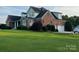 Brick two-story home featuring a well-maintained lawn and attached two-car garage at 140 Hunters Hill Dr, Statesville, NC 28677