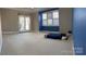 Large main bedroom with patio door, plush carpet, and light from the windows at 140 Hunters Hill Dr, Statesville, NC 28677