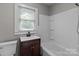 This bathroom features a vanity, toilet, and tub/shower combination, offering a functional and clean space at 1406 Upper Enochville Rd, Kannapolis, NC 28081