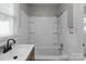 Well-lit bathroom featuring a tub and shower combination, plus a modern sink with a black faucet at 1406 Upper Enochville Rd, Kannapolis, NC 28081