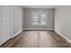 Bright bedroom showcasing warm vinyl flooring and a double window that provides ample natural light at 1406 Upper Enochville Rd, Kannapolis, NC 28081