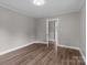Bedroom with neutral paint and wood-look laminate flooring at 1406 Upper Enochville Rd, Kannapolis, NC 28081