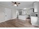 This spacious kitchen features white cabinets, stainless appliances, granite counters, and wood-look flooring at 1406 Upper Enochville Rd, Kannapolis, NC 28081