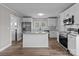 Modern kitchen featuring a large island, stainless steel appliances, and sleek white cabinets for ample storage at 1406 Upper Enochville Rd, Kannapolis, NC 28081