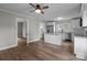Spacious kitchen with stainless appliances, granite countertops, an island, and wood-look flooring adjacent to dining area at 1406 Upper Enochville Rd, Kannapolis, NC 28081