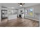 Bright, open kitchen with stainless steel appliances, white cabinetry, granite countertops, and wood-look flooring at 1406 Upper Enochville Rd, Kannapolis, NC 28081