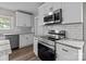 Beautifully updated kitchen with stainless steel appliances, white cabinets, and granite countertops at 1406 Upper Enochville Rd, Kannapolis, NC 28081