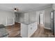 Modern kitchen with an island featuring granite countertops and seating, plus a view into other living spaces at 1406 Upper Enochville Rd, Kannapolis, NC 28081