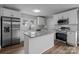 This bright, updated kitchen boasts a center island, stainless appliances, granite counters, and subway tile backsplash at 1406 Upper Enochville Rd, Kannapolis, NC 28081