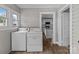 The laundry room features a full sized washer and dryer with a doorway view to the kitchen at 1406 Upper Enochville Rd, Kannapolis, NC 28081