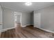 Open-concept living room with luxury vinyl plank flooring, light-gray walls, and white trim at 1406 Upper Enochville Rd, Kannapolis, NC 28081