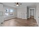 This living room offers wood-look floors, neutral walls, a fireplace, and large windows for natural light at 1406 Upper Enochville Rd, Kannapolis, NC 28081
