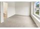Neutral bedroom with carpet, large window, and adjacent bathroom at 14123 Tranters Creek Ln, Charlotte, NC 28273