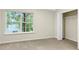 Cozy bedroom featuring a large window with backyard views and closet at 14123 Tranters Creek Ln, Charlotte, NC 28273