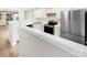 Well-lit kitchen features white cabinetry, modern appliances, and hardwood floors at 14123 Tranters Creek Ln, Charlotte, NC 28273