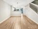 Bright, open-concept living room with hardwood floors and access to the kitchen area at 14123 Tranters Creek Ln, Charlotte, NC 28273