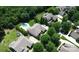 A drone's perspective showing the home's layout within the neighborhood, alongside green trees and a backyard pool at 14700 Old Vermillion Dr, Huntersville, NC 28078