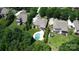 Overhead view of a house and neighborhood, showing a pool and well-maintained lawn and lush landscaping at 14700 Old Vermillion Dr, Huntersville, NC 28078