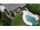 An aerial shot of a home with a screened-in porch, lush lawn and a beautiful kidney-shaped pool at 14700 Old Vermillion Dr, Huntersville, NC 28078